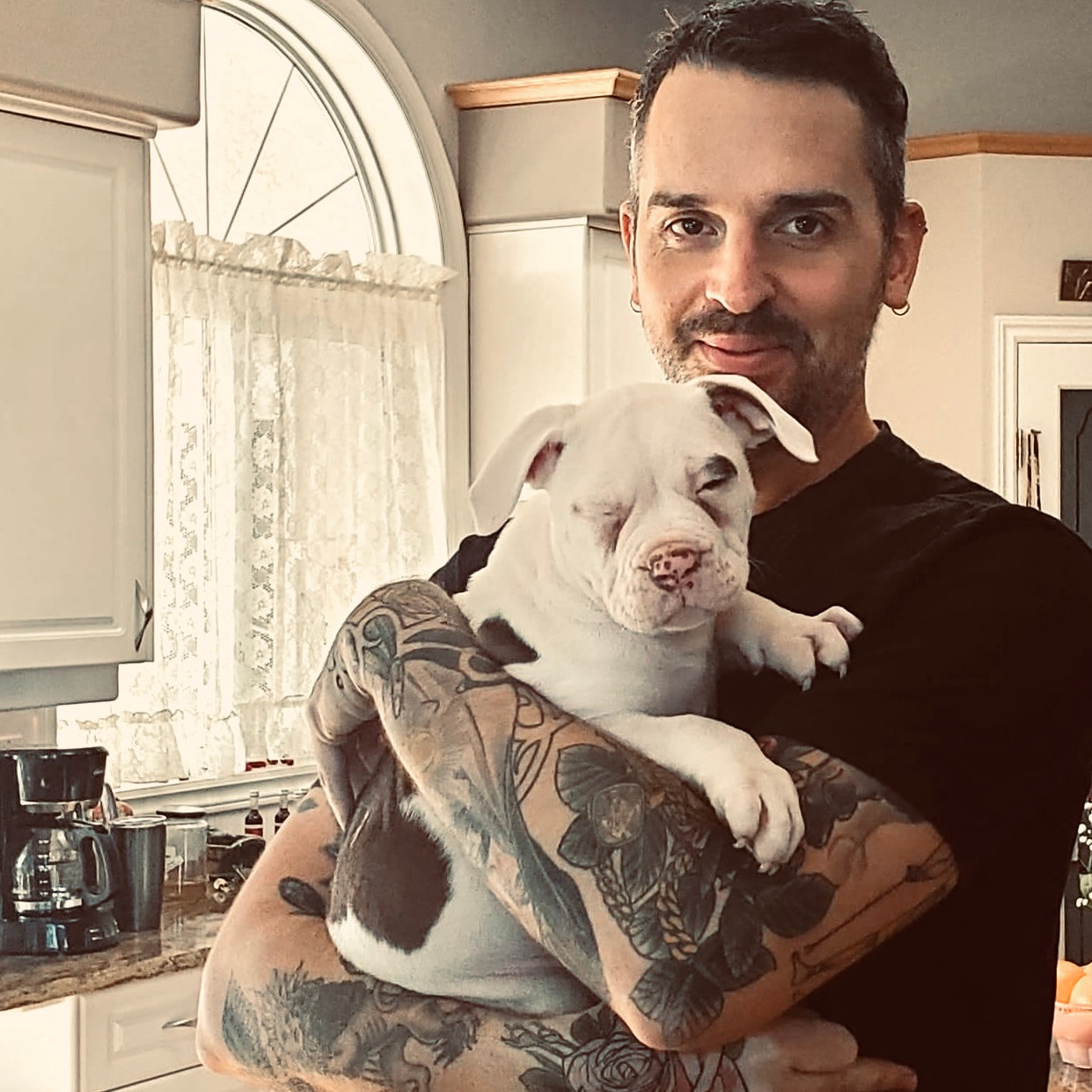 Jimmy the founder holding Tobey when he was just a little puppy.