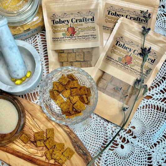 Tobey Crafted pumpkin spice quinoa crunchies with packaging, a mortar and pestle, and ingredients on a crochet doily tablecovering.