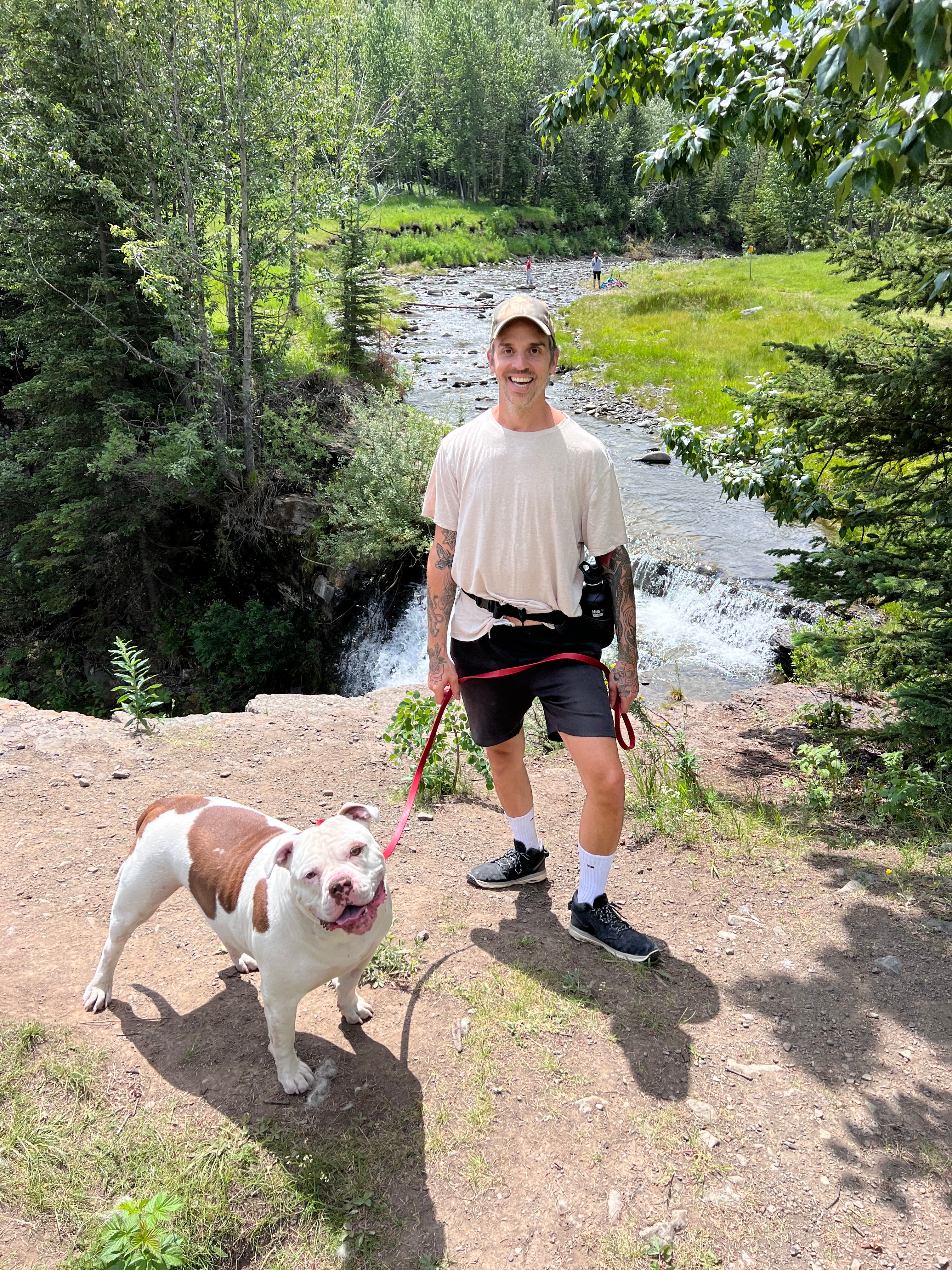 Tobey and James in front of a water fall and grass 
