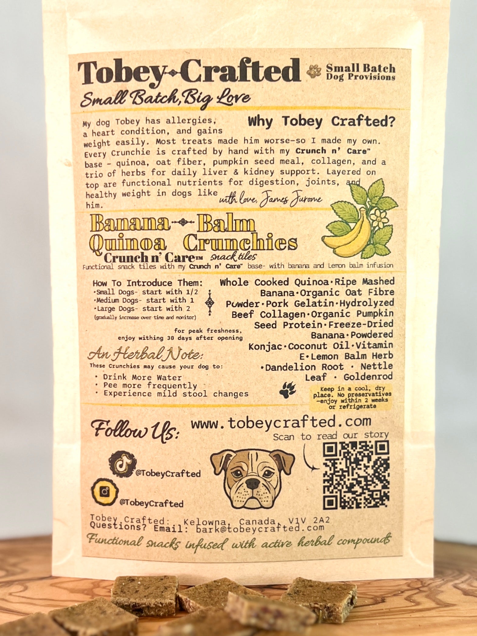 Tobey-Crafted dog treat packaging with text and a QR code on a wooden surface.