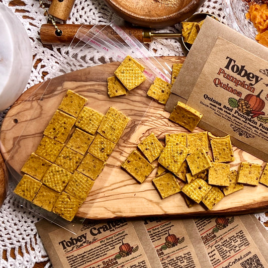 Quinoa crunchies sit on top of a wooden cutting board