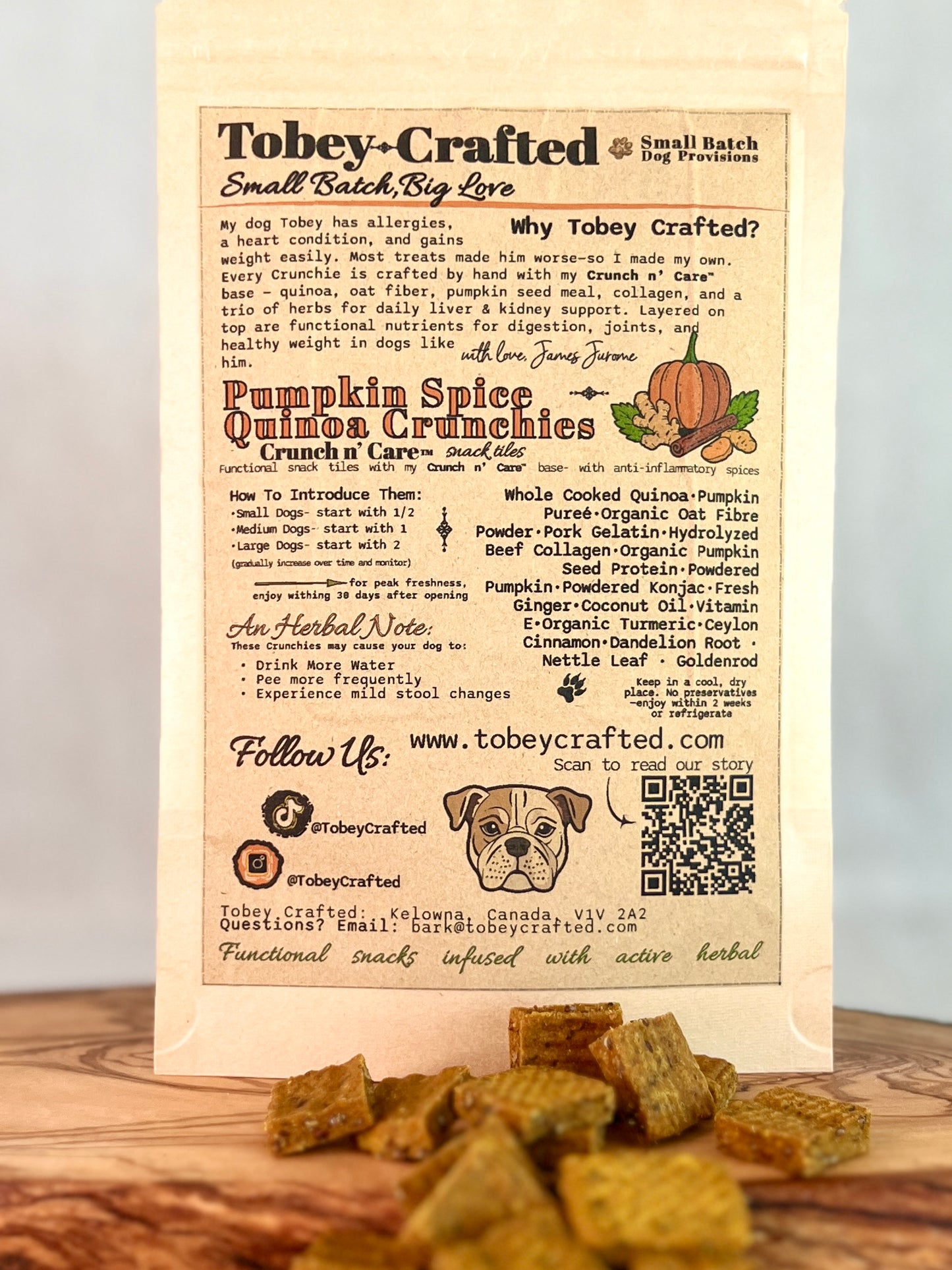 Tobey-Crafted dog treat packaging with text and a QR code on a wooden surface.
