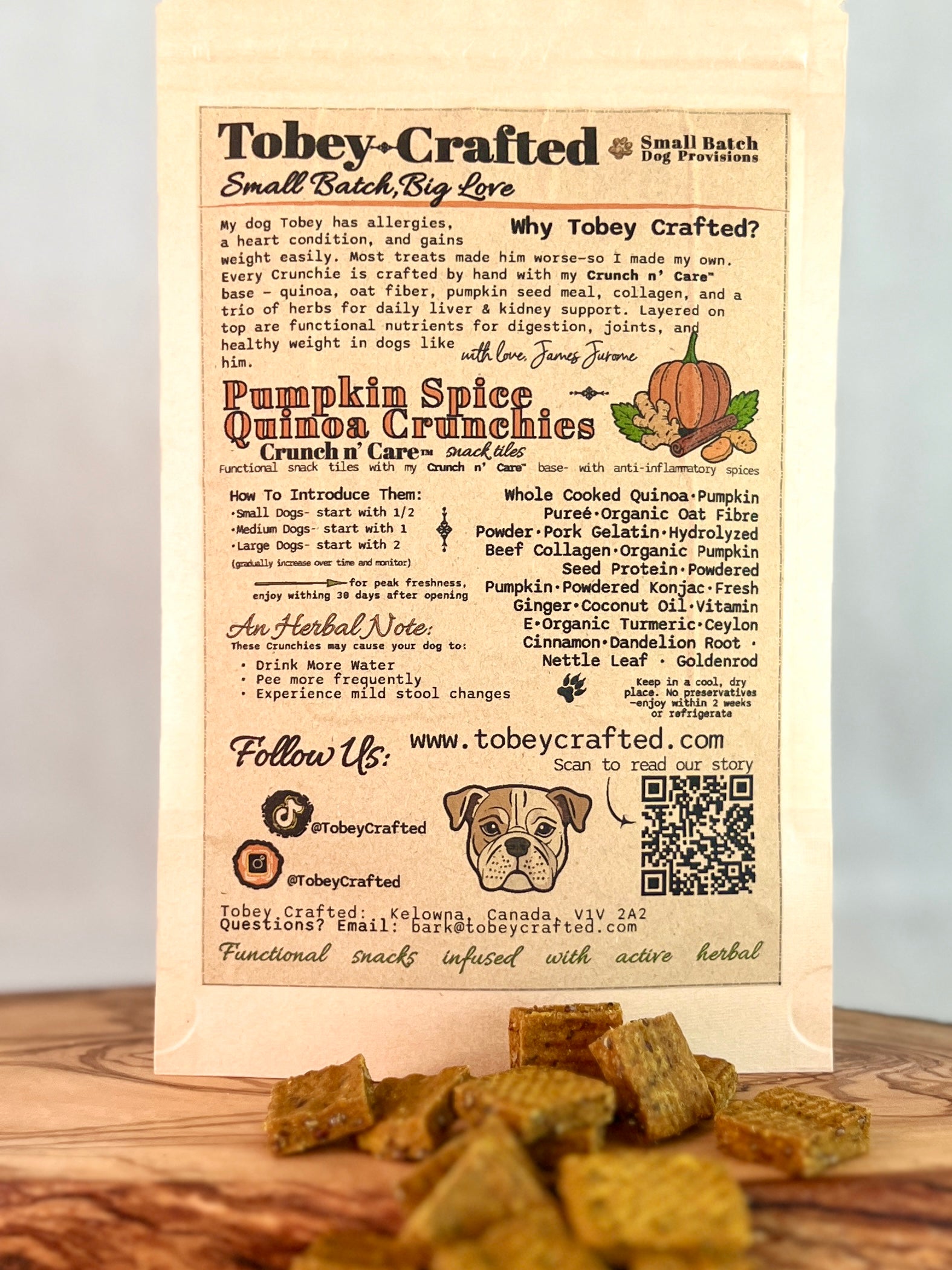 Tobey-Crafted dog treat packaging with text and a QR code on a wooden surface.
